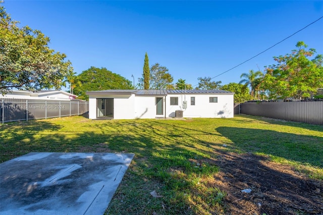 back of property with a yard and cooling unit