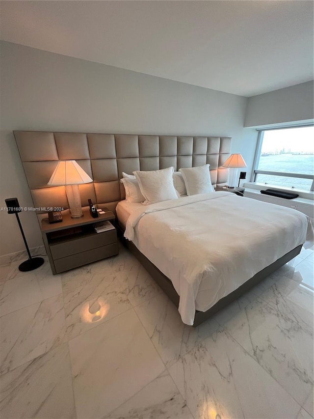 unfurnished bedroom featuring a water view