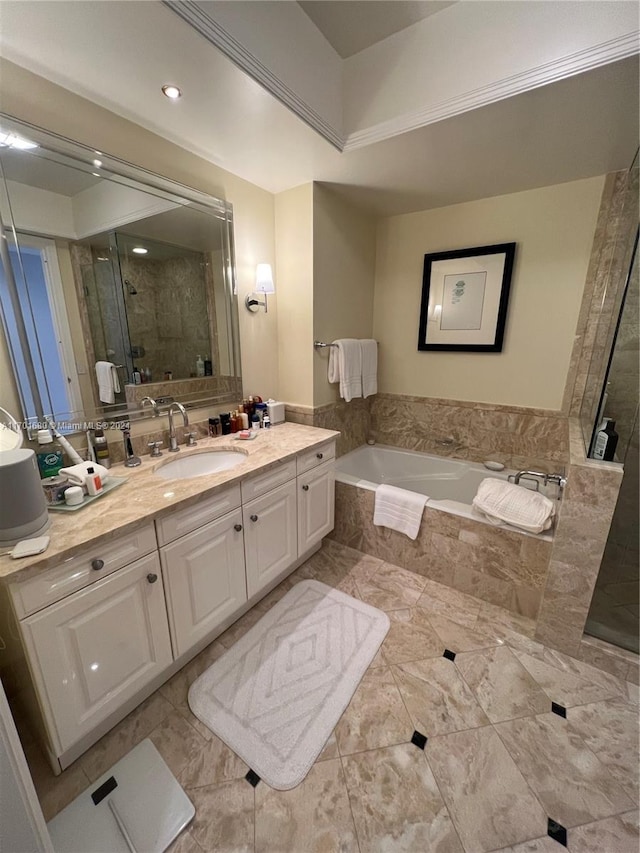 bathroom with vanity and shower with separate bathtub