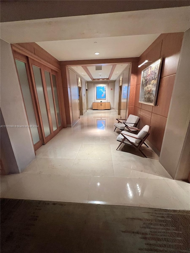 hallway featuring light tile patterned floors