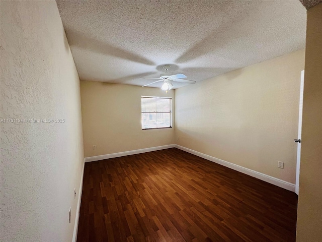 spare room featuring ceiling fan, dark hardwood / wood-style floors, and a textured ceiling