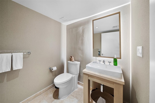 bathroom with tile patterned floors, toilet, and sink