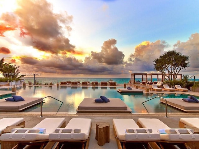 pool at dusk with a water view