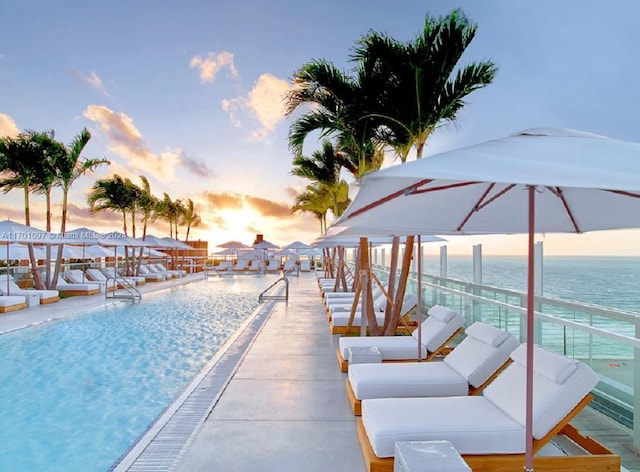 102 24th St Unit 1215, Miami Beach, FL 33139 - pool at dusk featuring a water view and a community pool