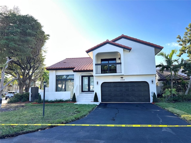 mediterranean / spanish-style house with a garage and a front lawn