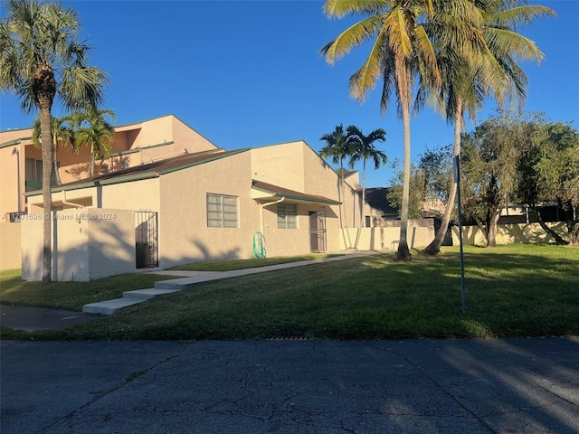 view of property exterior featuring a lawn