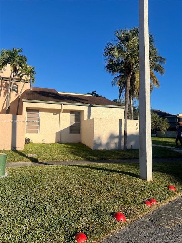 view of side of home featuring a yard