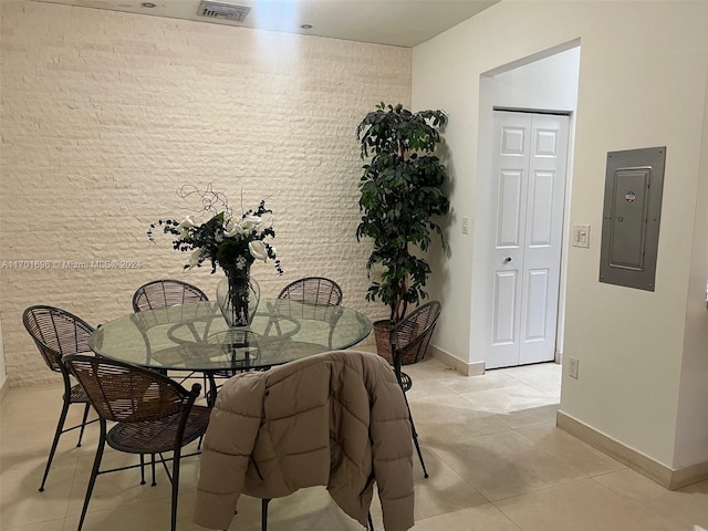 dining area featuring electric panel and light tile patterned floors