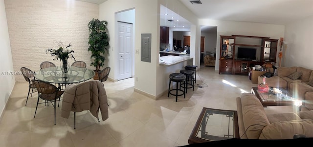 tiled dining space featuring electric panel