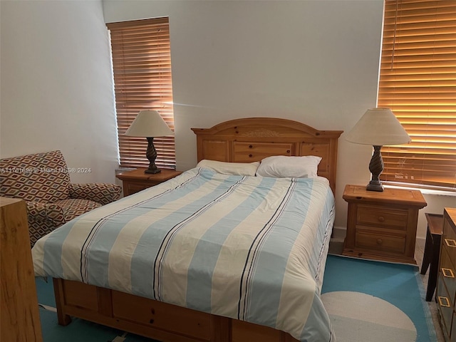 bedroom with dark colored carpet