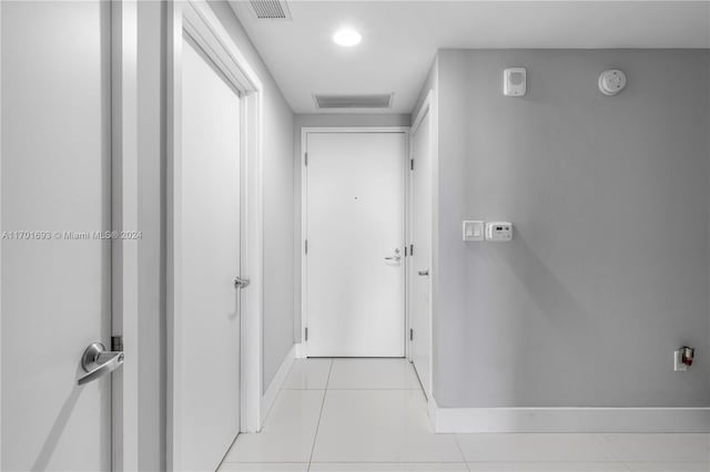 hallway featuring light tile patterned flooring