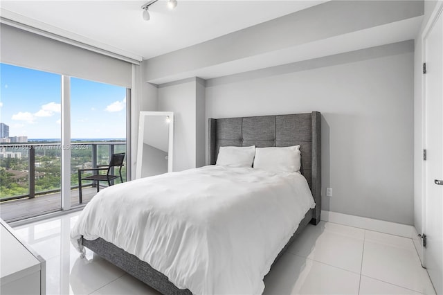 tiled bedroom featuring access to outside and track lighting