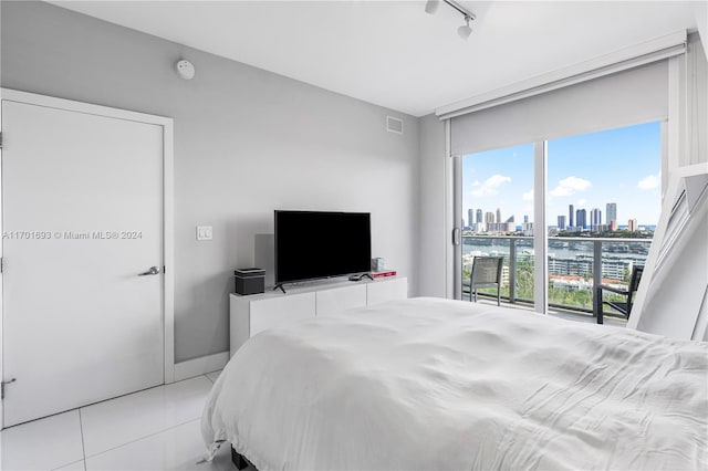 tiled bedroom featuring rail lighting