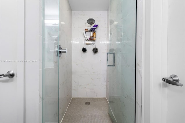 bathroom with a shower with shower door