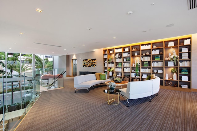 carpeted living room featuring a wall of windows