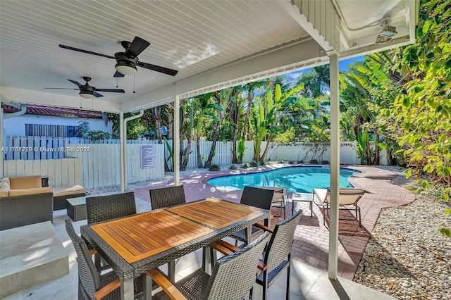 view of patio featuring a fenced in pool and ceiling fan