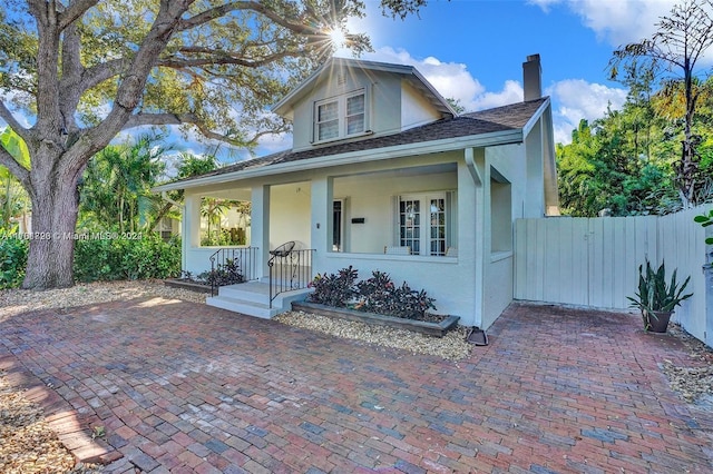 1640 Jefferson St, Hollywood, FL 33020 - bungalow-style home featuring a chimney, stucco siding, and covered porch