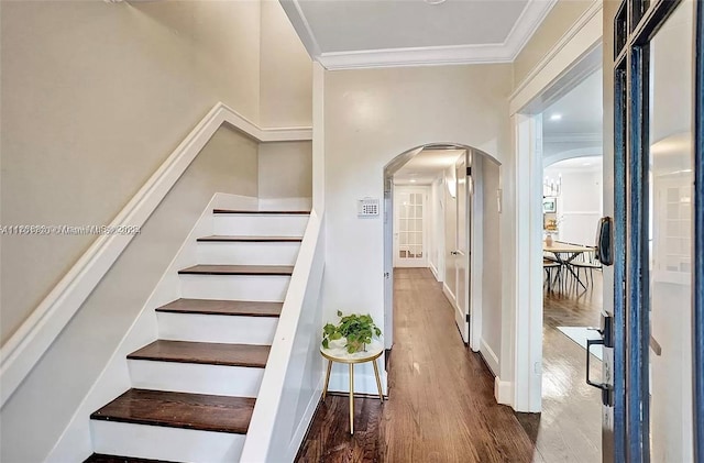 stairway featuring wood-type flooring and ornamental molding