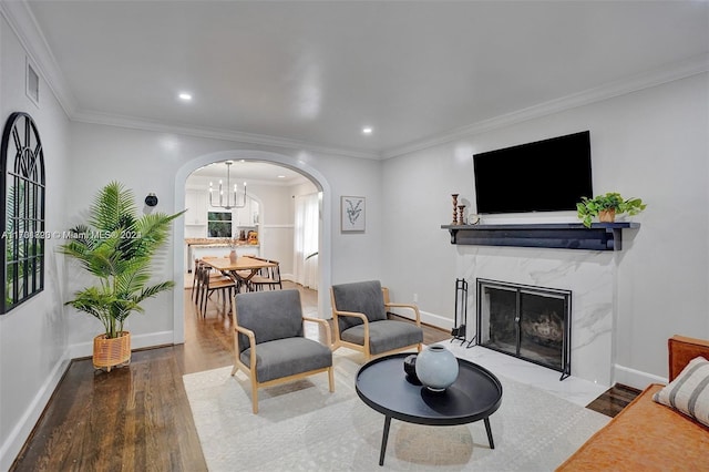 1640 Jefferson St, Hollywood, FL 33020 - living room featuring arched walkways, wood finished floors, a chandelier, baseboards, and ornamental molding
