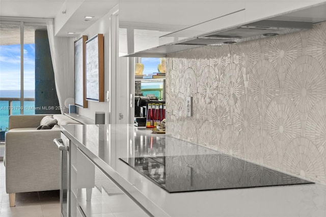 kitchen with light tile patterned flooring and a water view