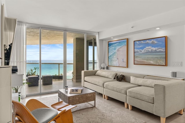 living room with a water view and a wall of windows