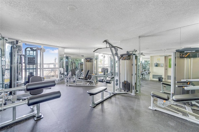 exercise room with a textured ceiling and floor to ceiling windows