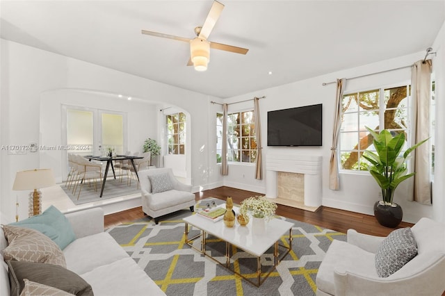 living room featuring hardwood / wood-style floors, french doors, and ceiling fan