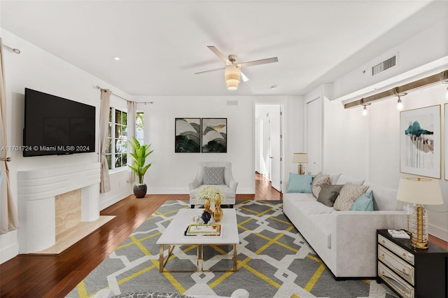 living room with dark hardwood / wood-style floors and ceiling fan