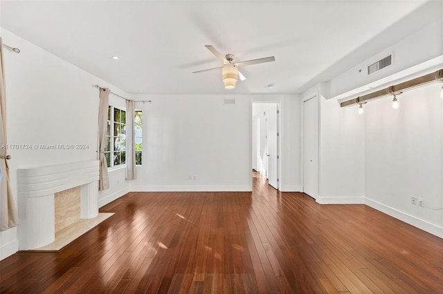 unfurnished living room with ceiling fan and dark hardwood / wood-style flooring