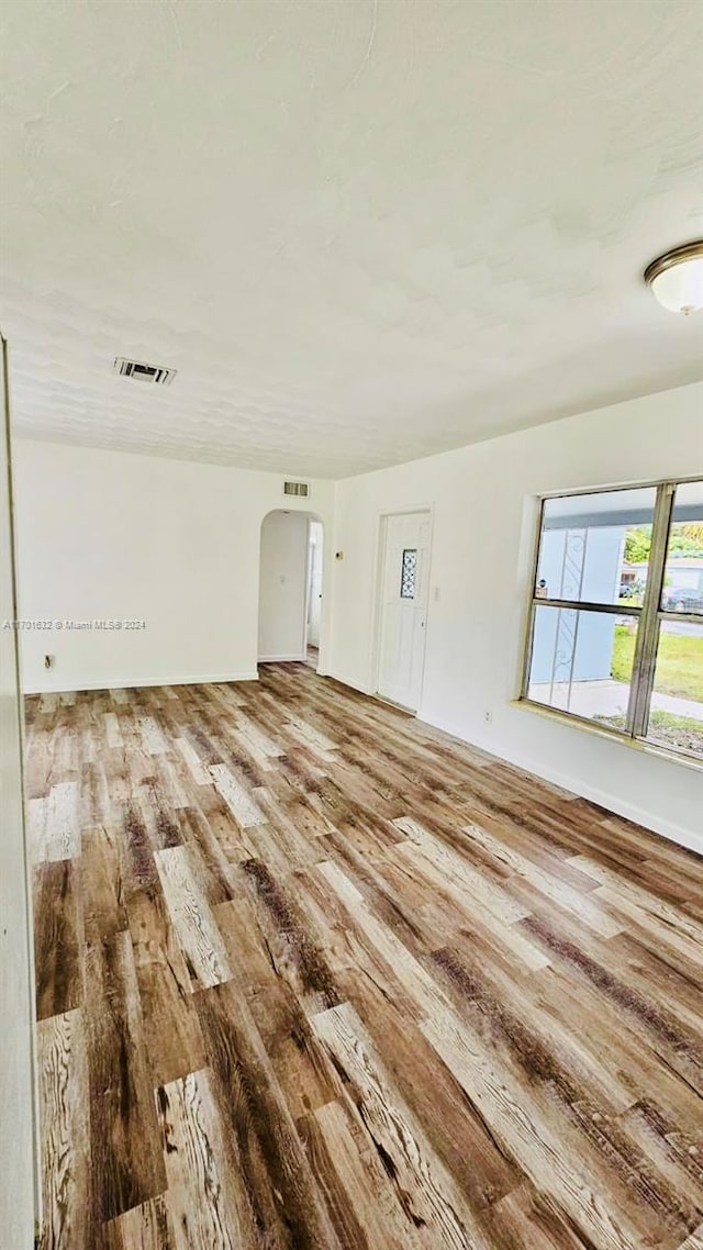 unfurnished room with hardwood / wood-style floors