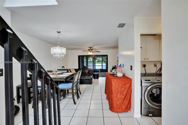 tiled dining room with ceiling fan and washer / clothes dryer