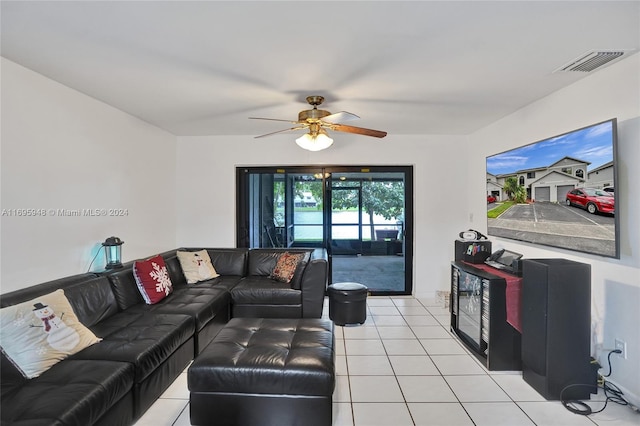 living room featuring ceiling fan and light tile patterned flooring