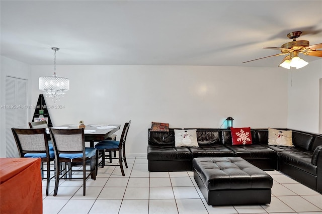 living room featuring light tile patterned floors and ceiling fan with notable chandelier