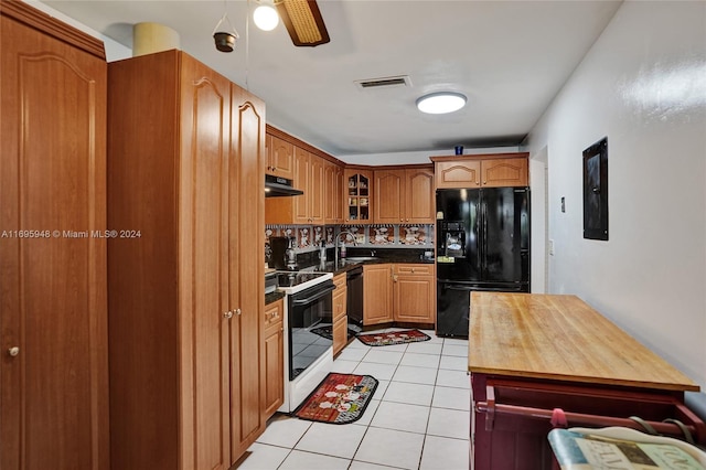 kitchen featuring decorative backsplash, ceiling fan, sink, black appliances, and light tile patterned flooring