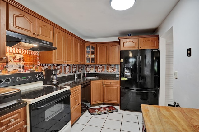 kitchen with black appliances, decorative backsplash, light tile patterned floors, and sink