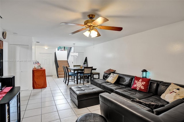 living room featuring light tile patterned floors and ceiling fan