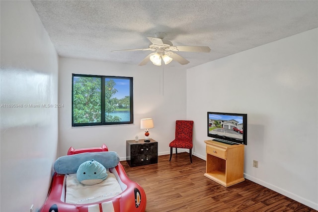 interior space with hardwood / wood-style floors, a textured ceiling, and ceiling fan