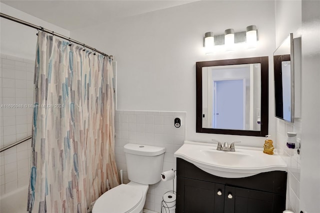 full bathroom featuring vanity, toilet, tile walls, and shower / tub combo with curtain