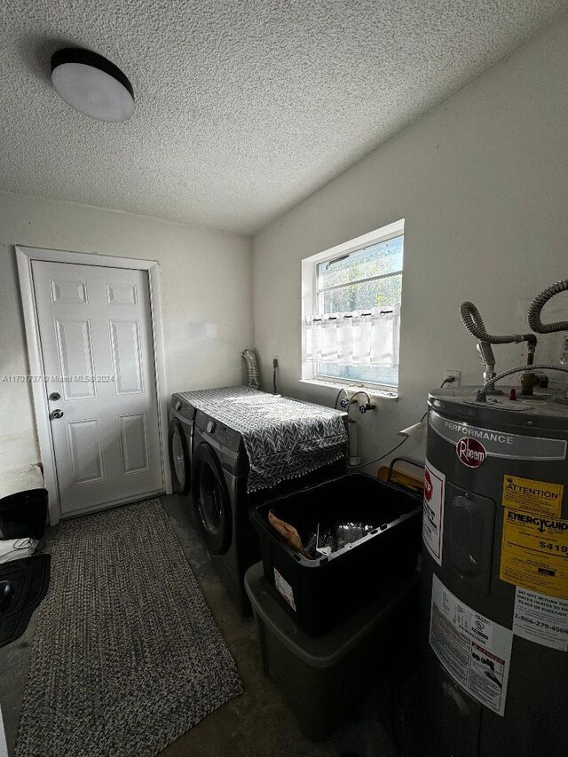 bedroom featuring a textured ceiling, washing machine and dryer, and water heater