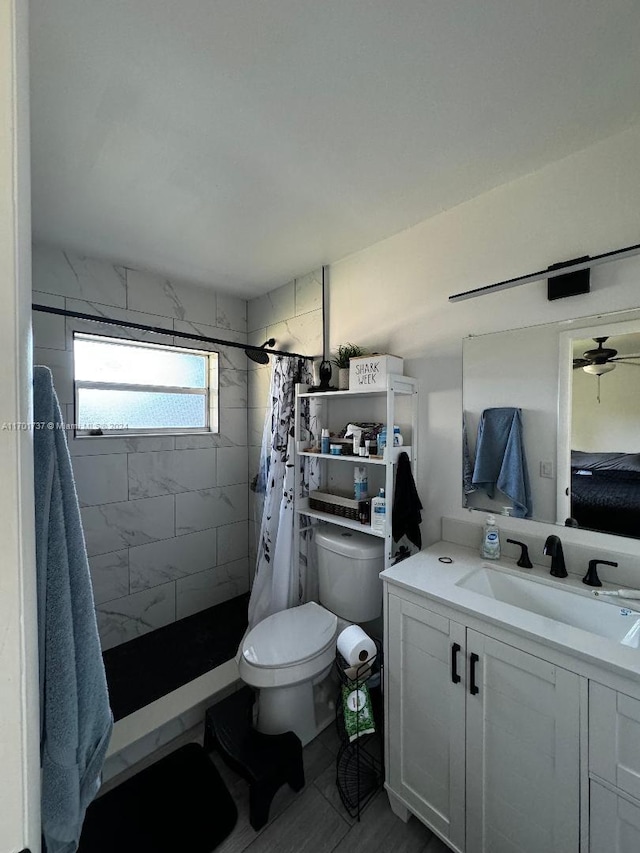 bathroom featuring vanity, toilet, and walk in shower