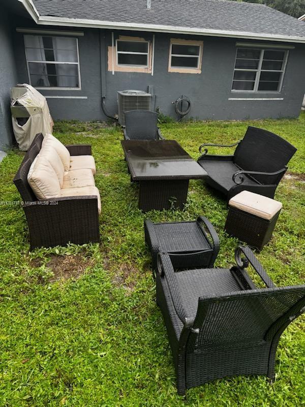 view of yard featuring central AC unit and an outdoor hangout area