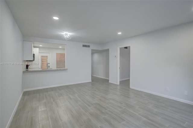 unfurnished living room with light hardwood / wood-style floors