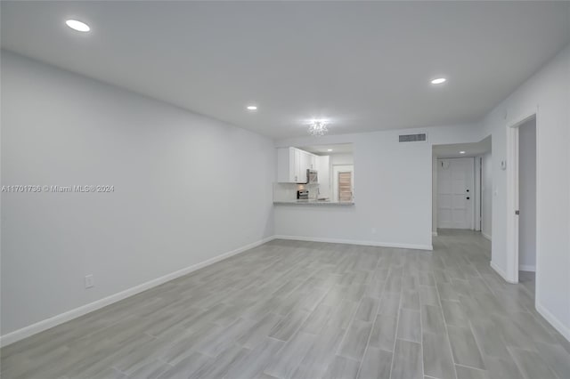 unfurnished living room featuring light hardwood / wood-style floors