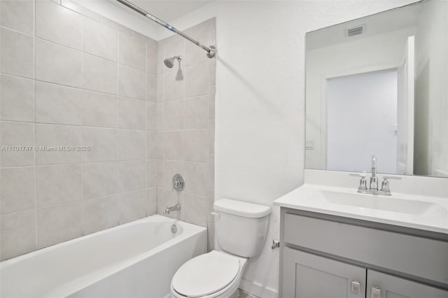 full bathroom featuring toilet, vanity, and tiled shower / bath