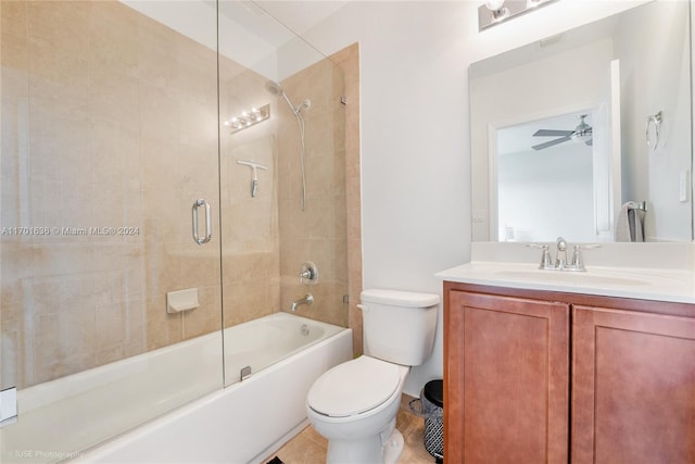 full bathroom with tile patterned floors, vanity, ceiling fan, shower / bath combination with glass door, and toilet