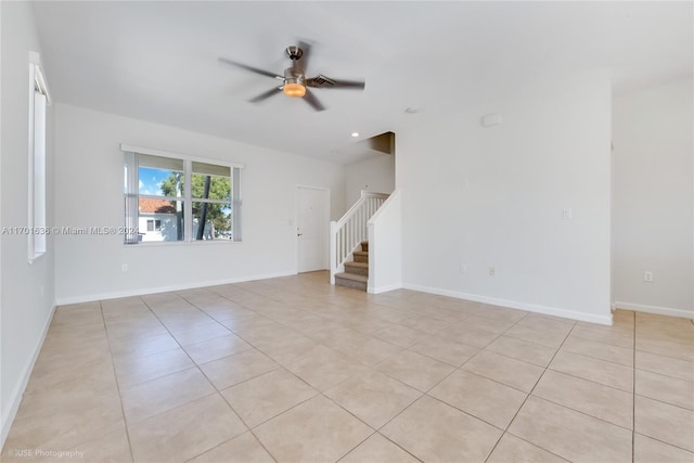 spare room featuring light tile patterned floors and ceiling fan