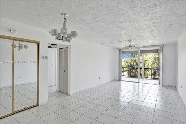 unfurnished room featuring a textured ceiling, ceiling fan, and light tile patterned flooring