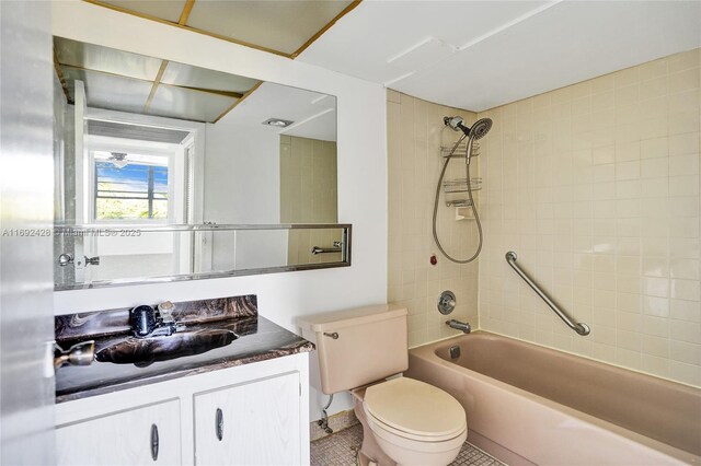 full bathroom with tile patterned flooring, vanity, toilet, and tiled shower / bath combo