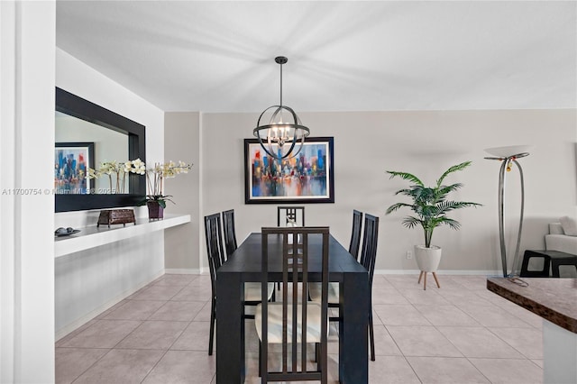 tiled dining area featuring a chandelier