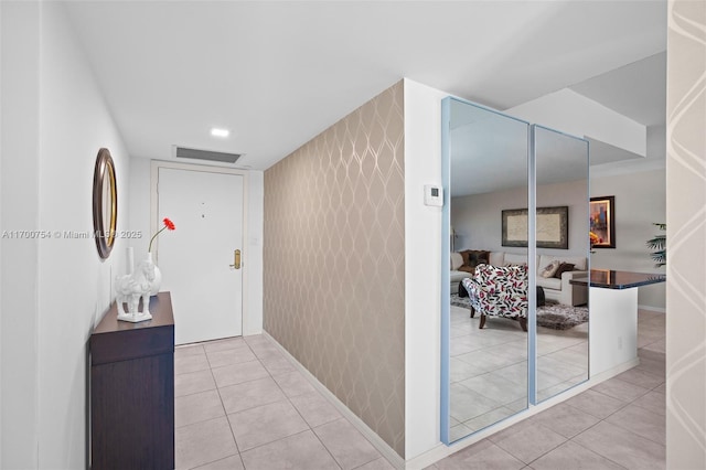 hall featuring light tile patterned flooring